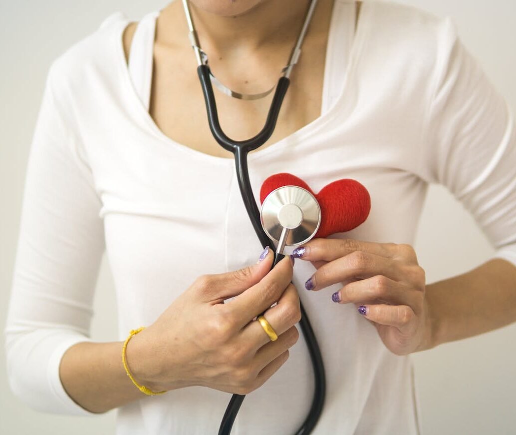 Semaglutide has BOTH Weight Loss & Cardiovascular Health benefits 1 Unrecognizable female wearing white shirt while standing on white background with diaphragm of stethoscope on red handmade heart in room