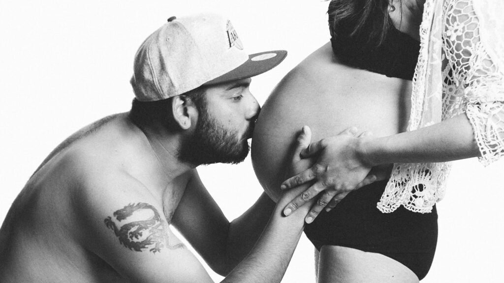 Surprise Pregnancies Linked to GLP-1 Medications Highlight Obesity and Fertility Connection 2 Grayscale Photography of Man Kissing Woman's Pregnant Bell