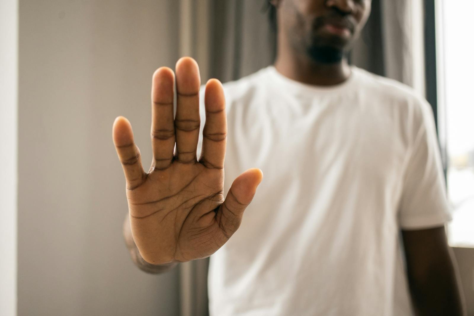 Reflection on the Importance of Pre-Filling Syringes at Our Clinic 1 Unrecognizable black man showing stop gesture